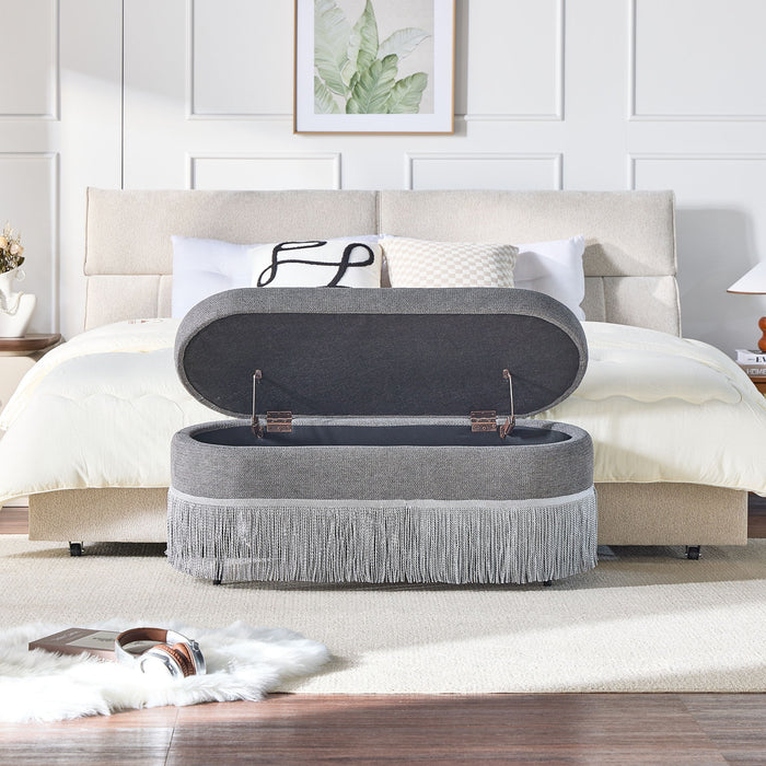 Oval Upholstered Storage Ottoman With Fringe Trim & Lift Top Lid
